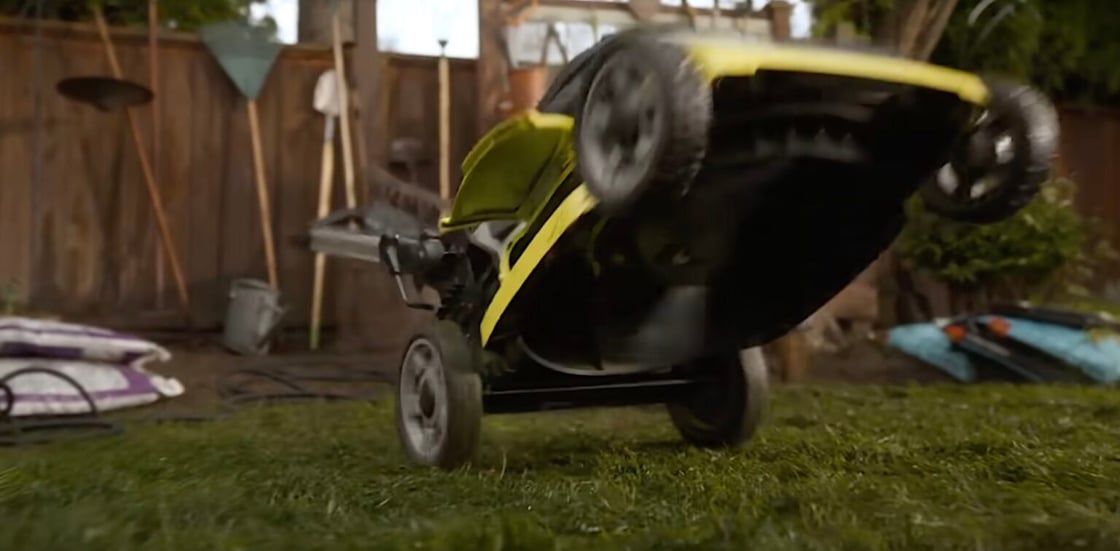 A screencap from Final Destination Bloodlines; a lawnmower revs forward