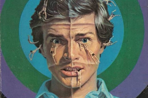 Detail from the cover of The Man Who Folded Himself by David Gerrold; small human figures swim above the startled face of a young man