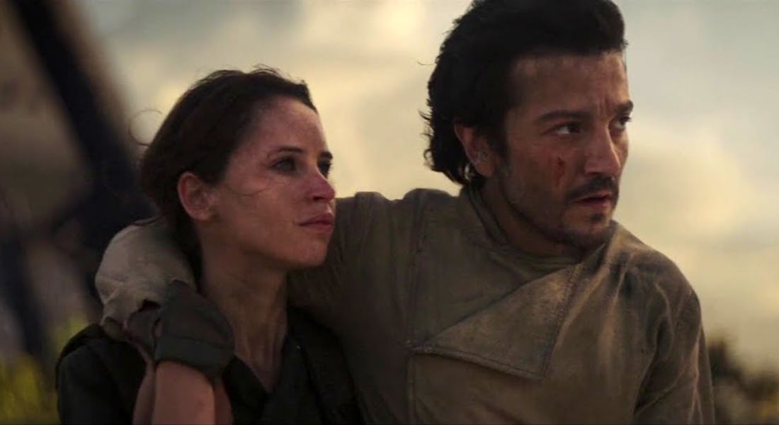 Jyn Erso (Felicity Jones) and Cassian Andor (Diego Luna) stand together during the final scene of Rogue One: A Star Wars Story