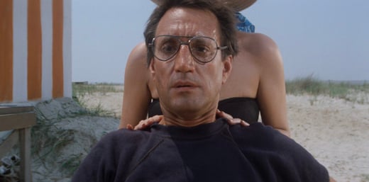 Sheriff Brody on the beach looking out in fear as a shark attack takes place in Jaws