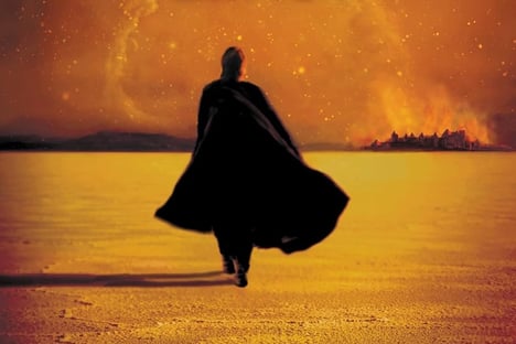 Detail from the cover of Matter by Iain M Banks; a shadowed figure walks on an orange desert