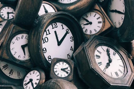 A pile of old, worn-down clocks