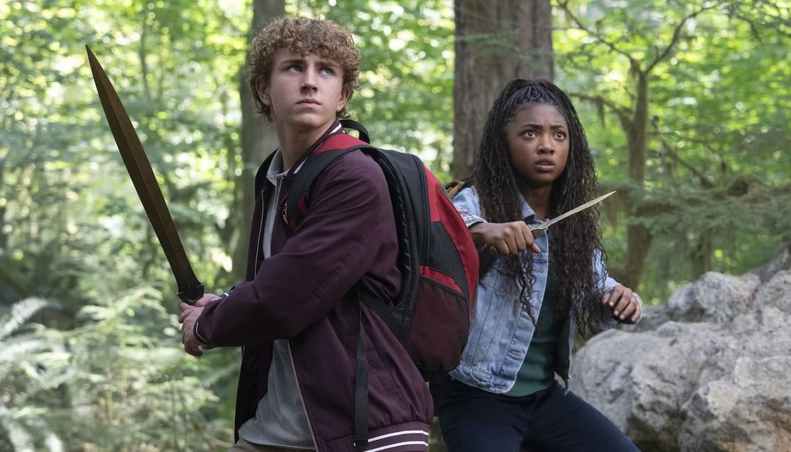 Percy Jackson and Annabeth standing in a forest, swords drawn