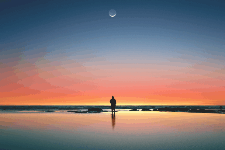 A single figure standing under the moon at sunset, shadow cast across a still body of water