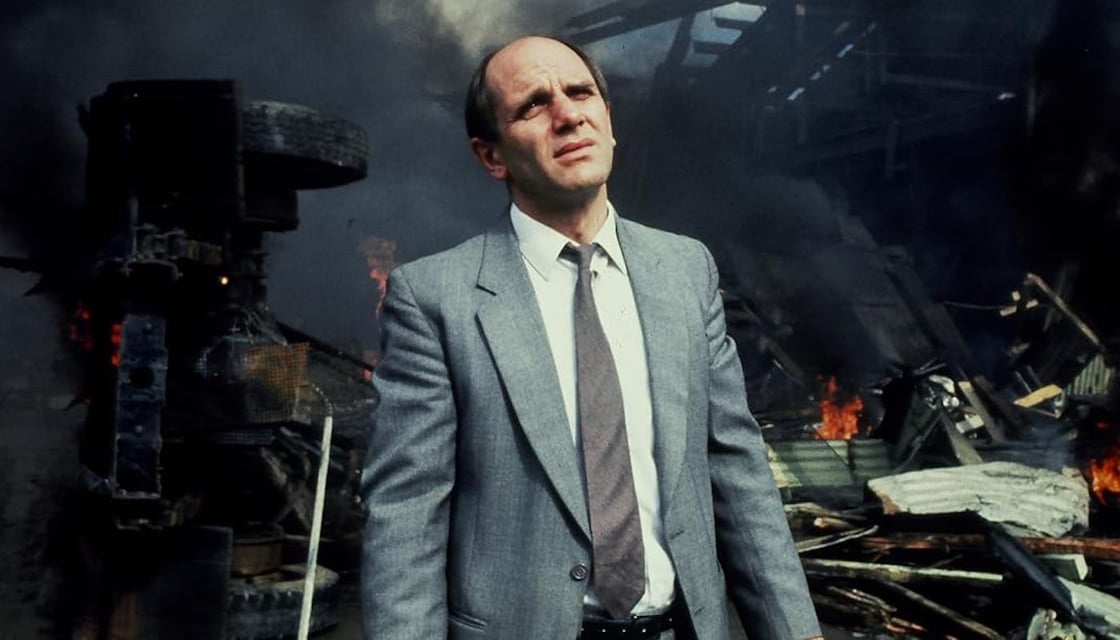 Bruno Lawrence as Zac Hobson in The Quiet Earth, standing in the wreckage of a building