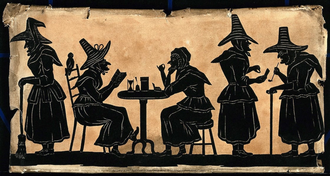 A print of 5 witches gathered around a table on brown corroded paper