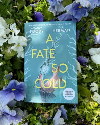 A bookstagram of an ARC of A Fate So Cold by Amanda Foody and C.L. Herman.