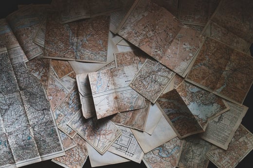 A photograph of a pile of maps