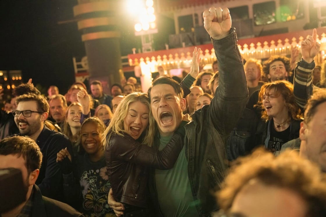 Chris and Harcourt holding onto each other and partying at a Foxy Shazam concert in Peacemaker's S2 finale, "Full Nelson"