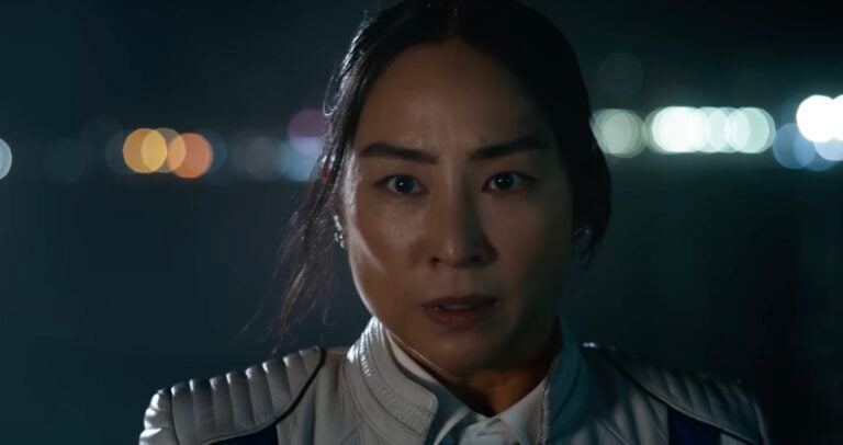 Eve Kim on a dock looking scared but fascinated in Tron: Ares