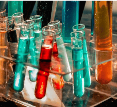 A photo of colorful red and green test tubes together on a rack